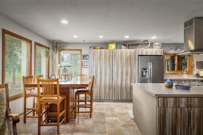 Dining space with a textured ceiling and recessed lighting | Image 26