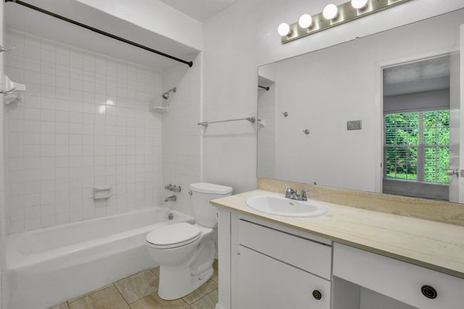 Full bathroom featuring vanity, tub / shower combination, and tile patterned floors | Image 18