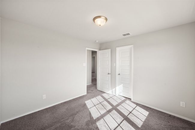 Unfurnished bedroom with carpet flooring, baseboards, and visible vents | Image 32