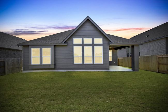 Back of property with a shingled roof, a patio, and a fenced backyard | Image 23