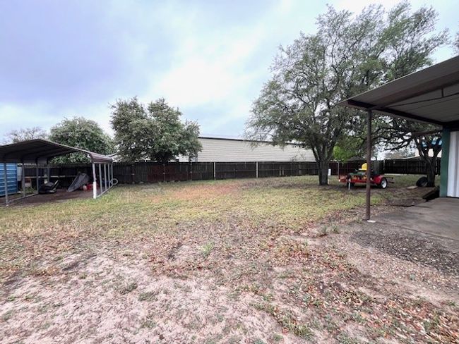 View of yard with a fenced backyard and a carport | Image 10