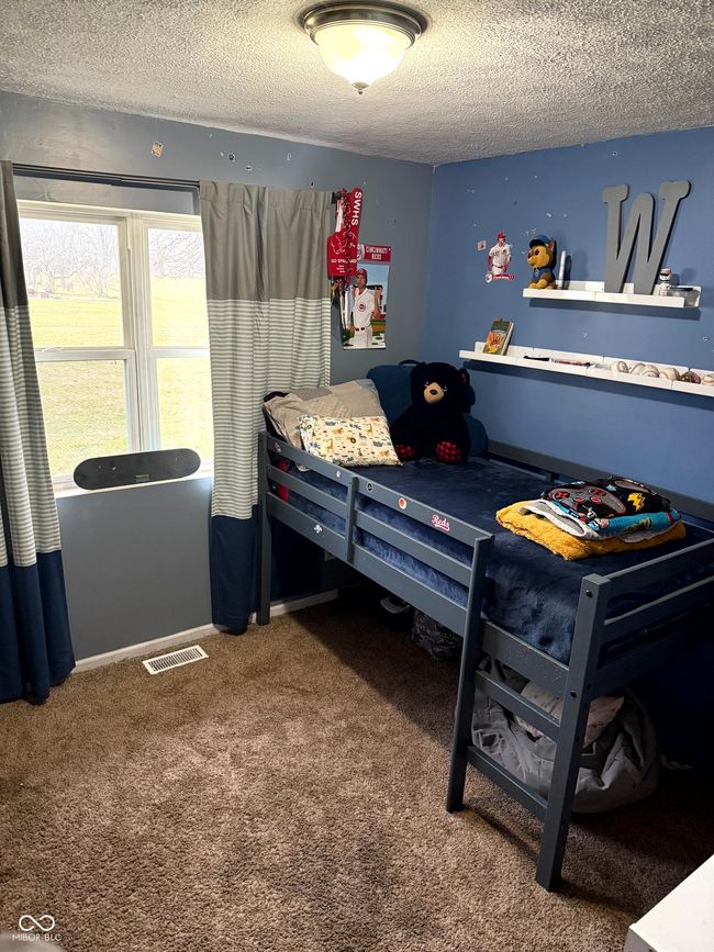 bedroom with a textured ceiling and carpet floors | Image 21