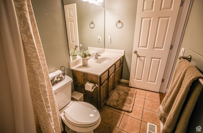 Full bath featuring toilet, tile patterned floors, and vanity | Image 33
