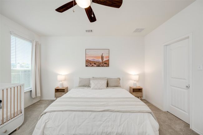 Bedroom with light colored carpet and a ceiling fan | Image 13