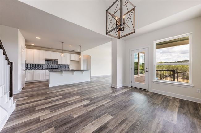 Open floor plan connects the large living room, dining room and kitchen. | Image 6