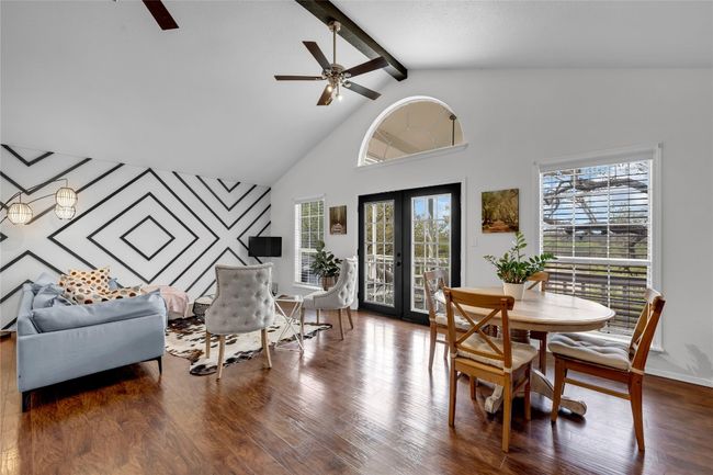 Dining space with wood finished floors, ceiling fan, and a healthy amount of sunlight | Image 11