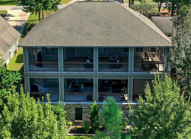Stunning drone view highlighting spacious upper and lower porches, perfect for relaxation and entertaining. | Image 38