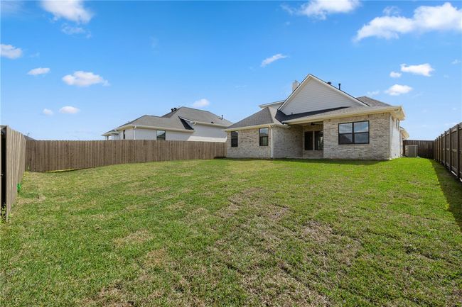 Rear view of house with a yard and central air condition unit | Image 28