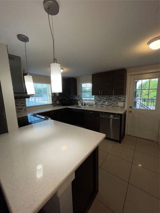 Kitchen with dishwashing machine, backsplash, and plenty of natural light | Image 7