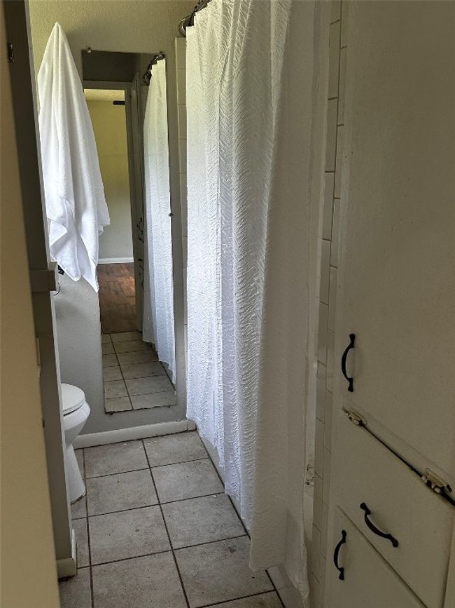 Full bath with tile patterned flooring and shower / tub combo with curtain | Image 15