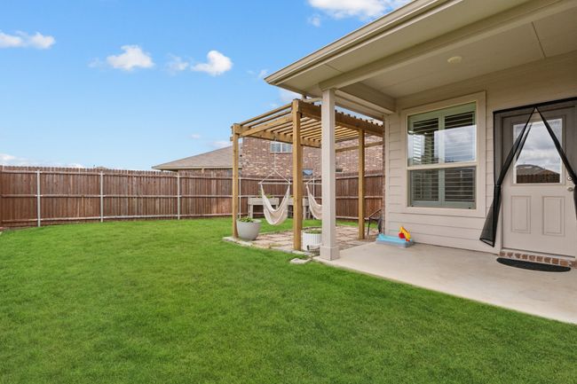 Fenced backyard featuring a pergola and a patio | Image 25