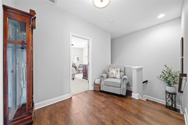 Sitting room featuring baseboards, an upstairs landing, and wood finished floors | Image 16