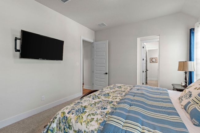Carpeted bedroom with lofted ceiling, visible vents, and baseboards | Image 20