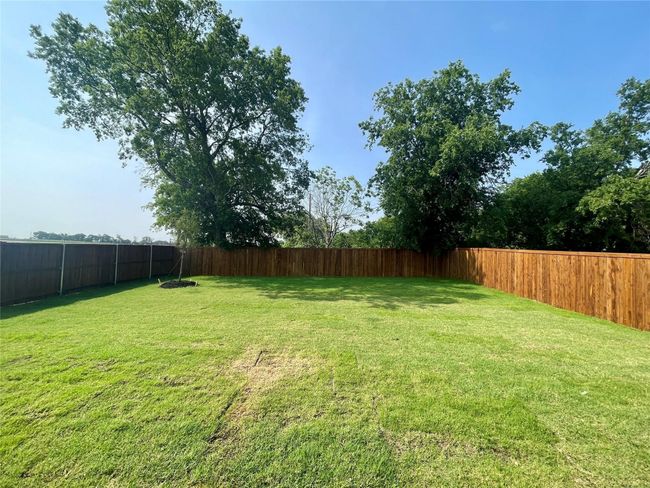 View of fenced backyard | Image 37