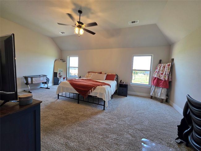 Bedroom with lofted ceiling, carpet, and ceiling fan | Image 21