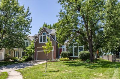 View of front of house with a front lawn and a garage | Image 2