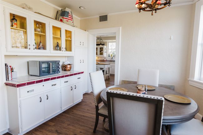 Dining space with dark hardwood / wood-style floors, sink, an inviting chandelier, and ornamental molding | Image 20