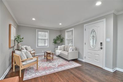 Living room featuring refinished hardwood floors and ornamental molding | Image 3