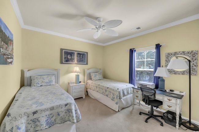 Carpeted bedroom featuring crown molding, a desk, and a ceiling fan | Image 19