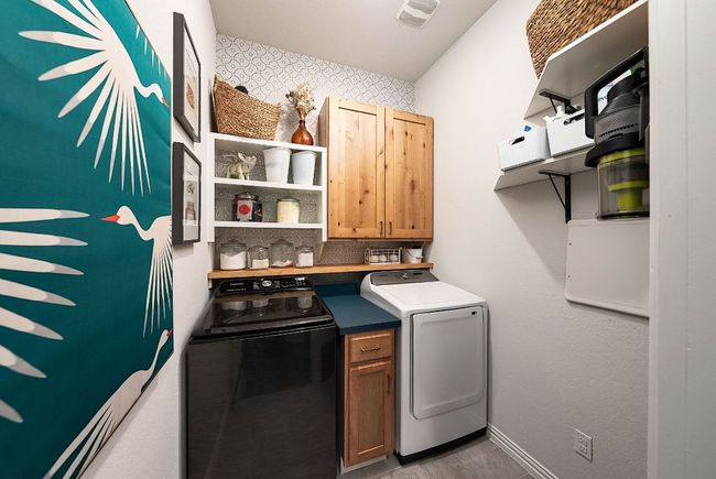Laundry room features added cabinetry, storage shelves, wallpaper, and a barn door (space saver) | Image 9
