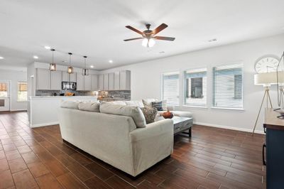 Living room with ceiling fan, a wealth of natural light, and dark hardwood / wood-style floors | Image 2