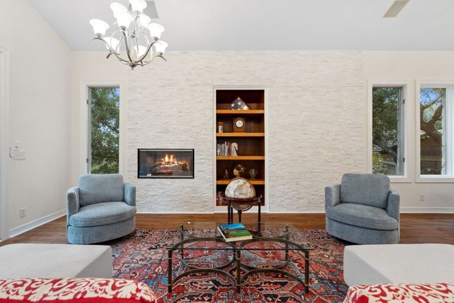 Cozy up by the fireplace in the main-level living room. | Image 7