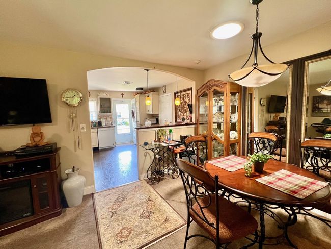 Dining room featuring arched walkways and carpet | Image 7