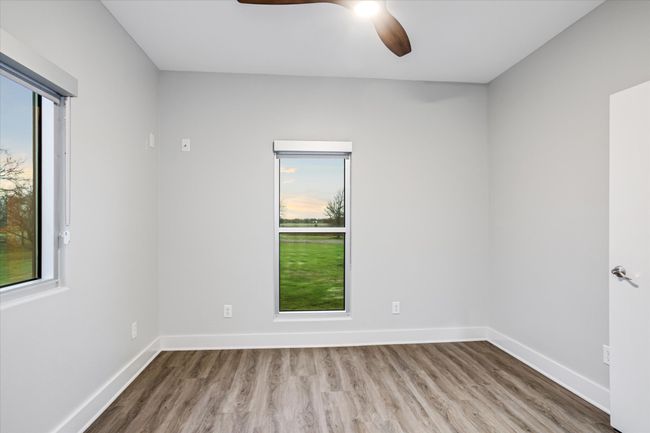 Spare room with hardwood / wood-style flooring, a wealth of natural light, and ceiling fan | Image 16