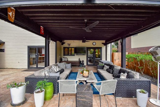 View of the screened patio area looking toward the house. | Image 44