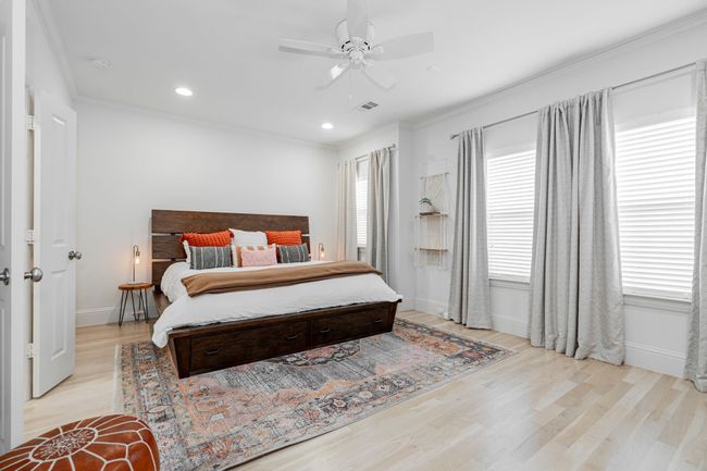 Bedroom featuring ornamental molding, a ceiling fan, and light wood-style flooring | Image 16