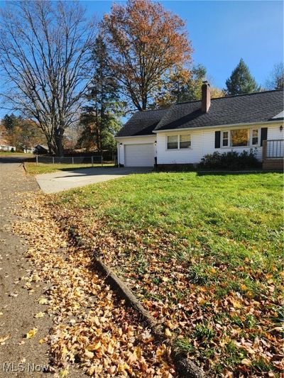 View of property exterior featuring a garage and a yard | Image 2