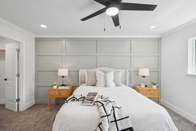 Bedroom featuring a decorative wall, ornamental molding, carpet, recessed lighting, and a ceiling fan | Image 25