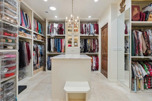 The owners thought of everything when out-fitting this expansivecloset! The custom-designed "department store 'box style'cabinetry provides 3 levels of hanging space, 2 floor-to-ceiling "dressers, " each with 5 large lower drawers and upper glass-shelvedand lighted display behind framed-glass doors. | Image 26