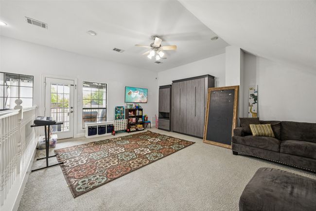 Living area featuring carpet floors, ceiling fan, and vaulted ceiling | Image 27