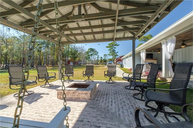 View of patio / terrace with a gazebo, ceiling fan, and an outdoor fire pit | Image 25