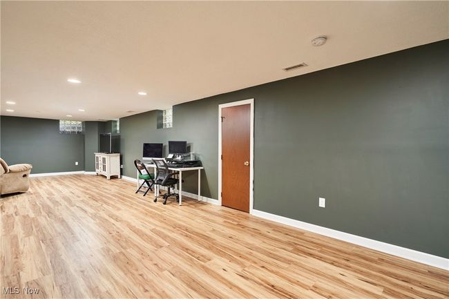 Office space featuring light wood finished floors, recessed lighting, and baseboards | Image 22