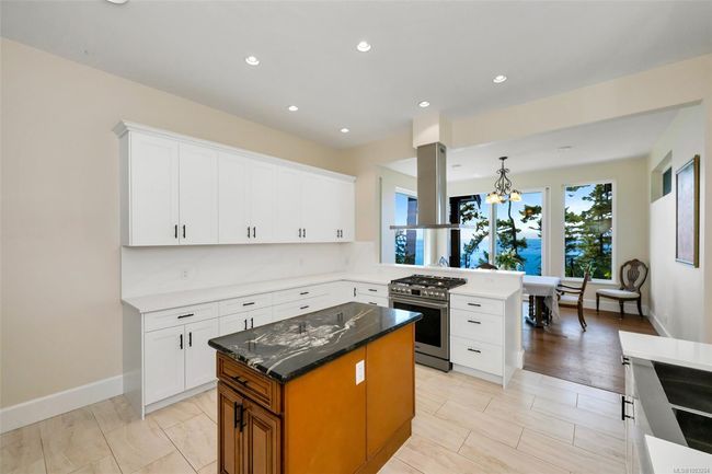 Living area with wood finished floors, a towering ceiling, and recessed lighting | Image 7
