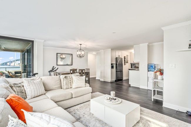 Living area featuring ornamental molding, dark wood finished floors, and a chandelier | Image 18