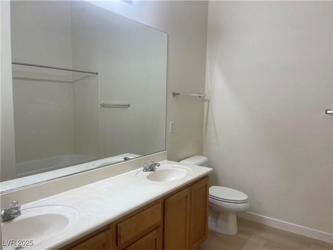 Full bath with double vanity, wood finished floors, and bathing tub / shower combination | Image 21