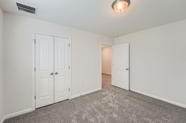 Unfurnished bedroom featuring carpet, visible vents, a closet, and baseboards | Image 22