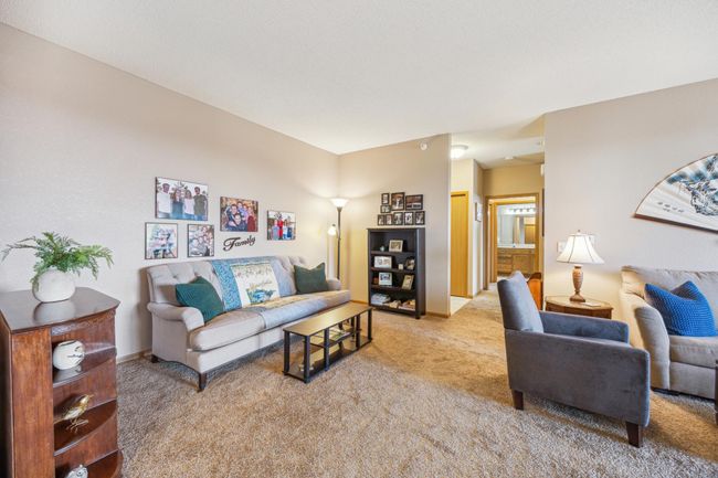 The back space of the living room offers endless possibilities - use as a dining or game table area, home office, piano corner, or cozy second sitting area, all in a seamless, open flow. | Image 9