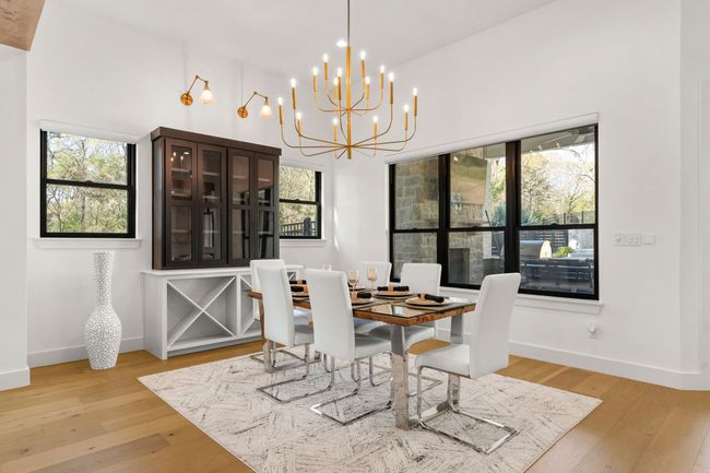 Dining area with a healthy amount of sunlight, a chandelier, and light wood-type flooring | Image 7