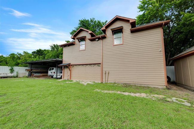View of home's exterior with driveway and a garage | Image 34