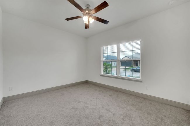 Empty room featuring carpet, baseboards, and a ceiling fan | Image 13