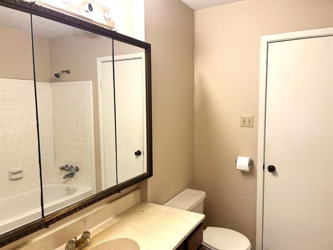 Here's the full bathroom, which can be accessed from the primary bedroom or the hallway... | Image 12