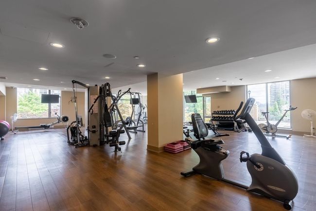 Workout area with wood finished floors, recessed lighting, and baseboards | Image 9