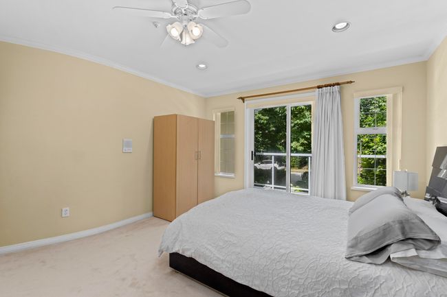 Bedroom with light colored carpet, ornamental molding, ceiling fan, and recessed lighting | Image 19