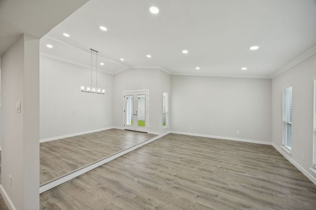 To your right as you enter, you will see the spacious living and formal dining area. NEW lighting and NEW French door that has views of the large side area of your backyard! | Image 8