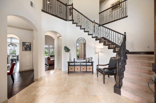 Once inside you are greeted by a 2 story foyer offering access to the dining, main living, and stairs leading the the second floor balcony. | Image 6
