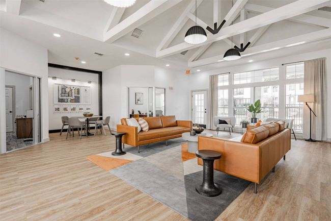 Living room with beamed ceiling, light hardwood / wood-style flooring, high vaulted ceiling, and french doors | Image 40